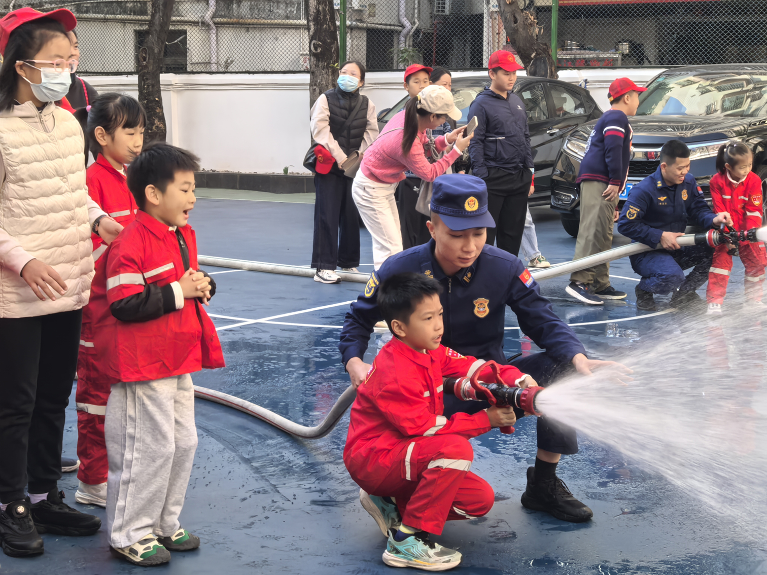 日前,桃源街道大学城社区民生微实事项目“大‘学’无界,携手‘童’行”——“启航者计划”系列主题活动圆满落幕。消防员手把手教孩子们使用消防水枪。桃源街道 供图.jpg